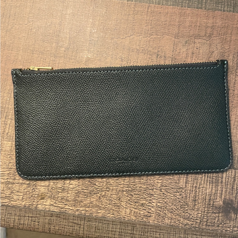 Green coach wallet with card slots and brass detail. Brand new never used.